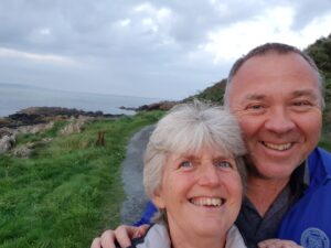 Sue and Des from Weymouth are smiling at the camera