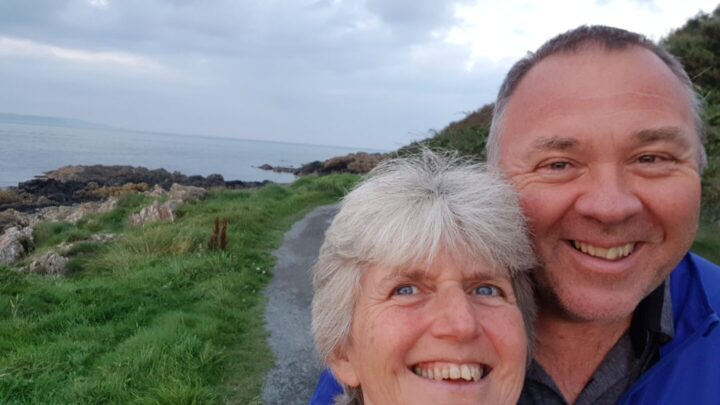 Sue and Des from Weymouth are smiling at the camera