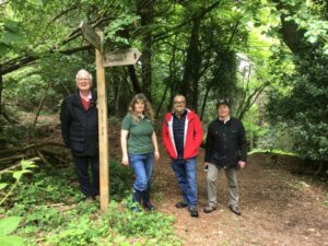 Individuals walking the new sections of coast path link