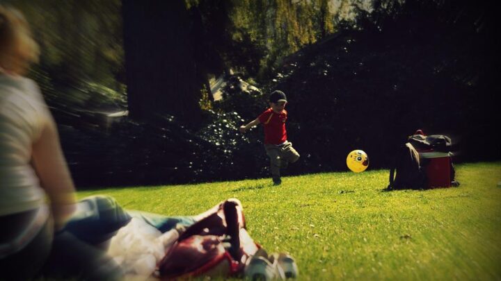 picture of little boy playing football