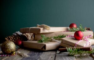 Image of presents, holly, and Christmas baubles
