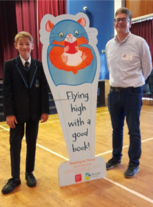 A young boy poses with an illustrated hamster and author David Solomon