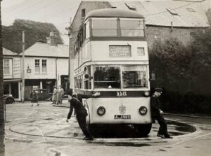 Black and white photograph of a yellow bus
