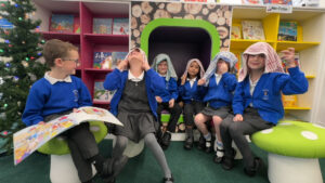 A photo of school children wearing tea towels over their heads, pretending to be shepherds