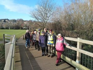 Walking group standing for picture on bridge