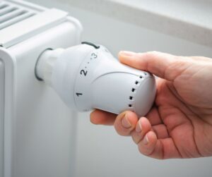 Person adjusting radiator