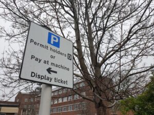 Street sign displaying parking information