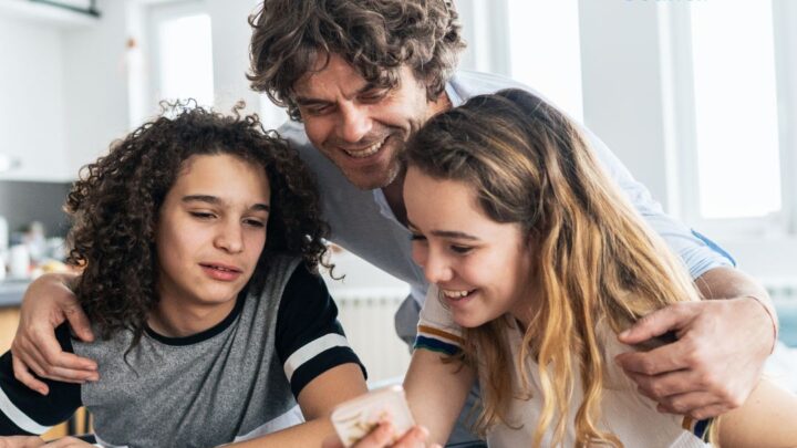 Man with two girls doing homework