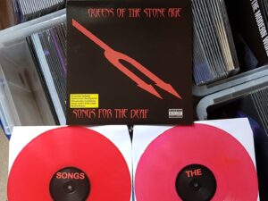 Vinyl album cover and two red coloured records for Queens of the Stone Age album "Songs for the Deaf"