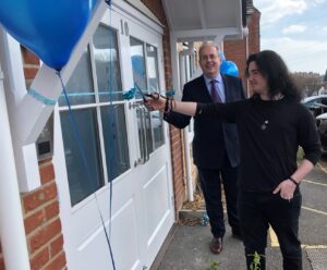 Peer landlord Shae and Cllr Parry cut the ribbon on the official opening of the new building that will provide homes for care leavers.