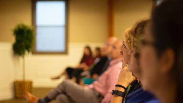 Delegates listening to a speaker at an event