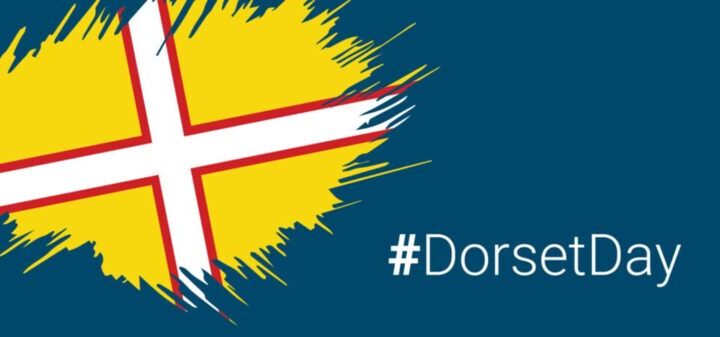 Yellow flag with a white and red cross, with the text hashtag Dorset Day.
