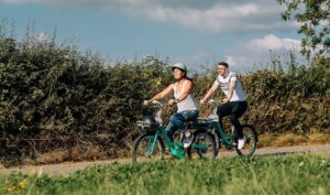 Two people riding bicycles in the countryside