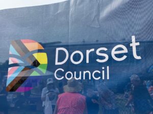 Pride flag showing Dorset Council logo