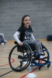 girl in wheelchair in indoor sports hall