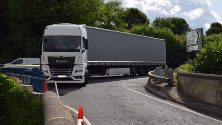 a big heavy goods vehicle lorry approaching a narrow bridge