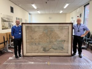 Staff at Dorset History Centre with the 1834 Percy map of Sherborne.