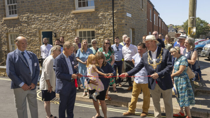 Resident Mandy Knott and grand-daughter cutting the ribbon at the Old Coal Yard, Bridport