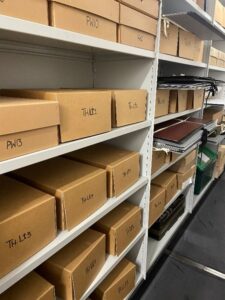 Shlving unit with boxes on shelves. This is the hardy archive at Dorset History Centre