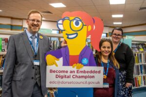 Three embedded digital champion recruits from Weymouth Library, pictured with Dorset Council's first embedded digital champion recruit - Digital Norma.