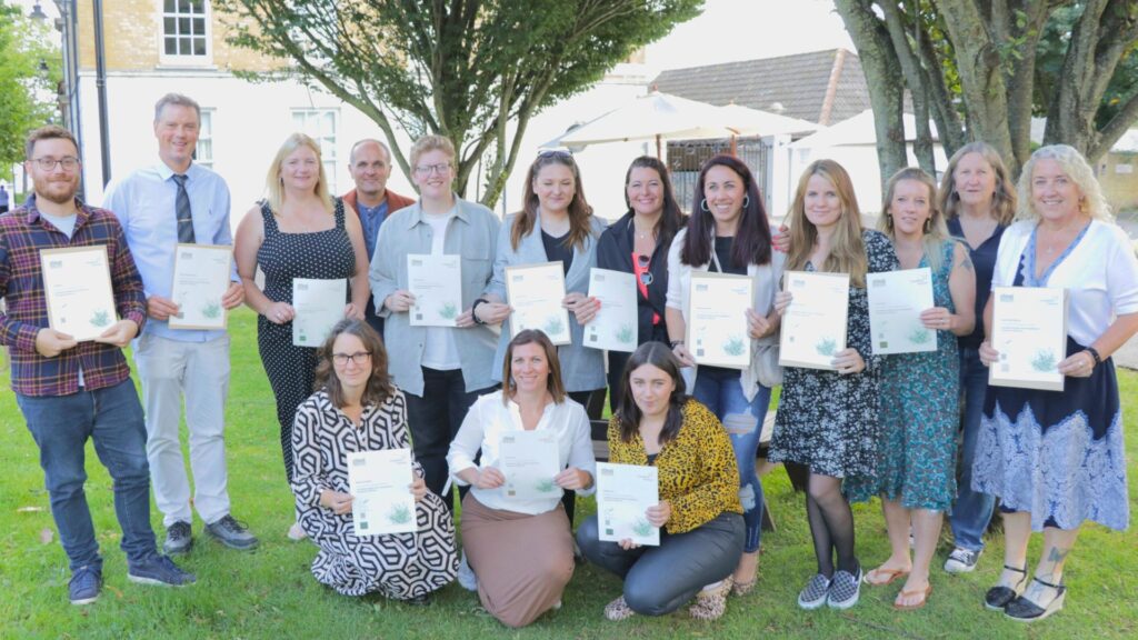 a group of people smiling at the camera holding certificates