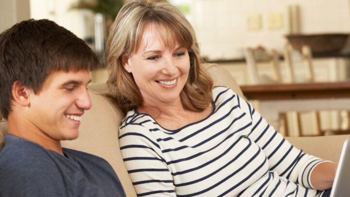 A woman is helping a young person to fill out a cv
